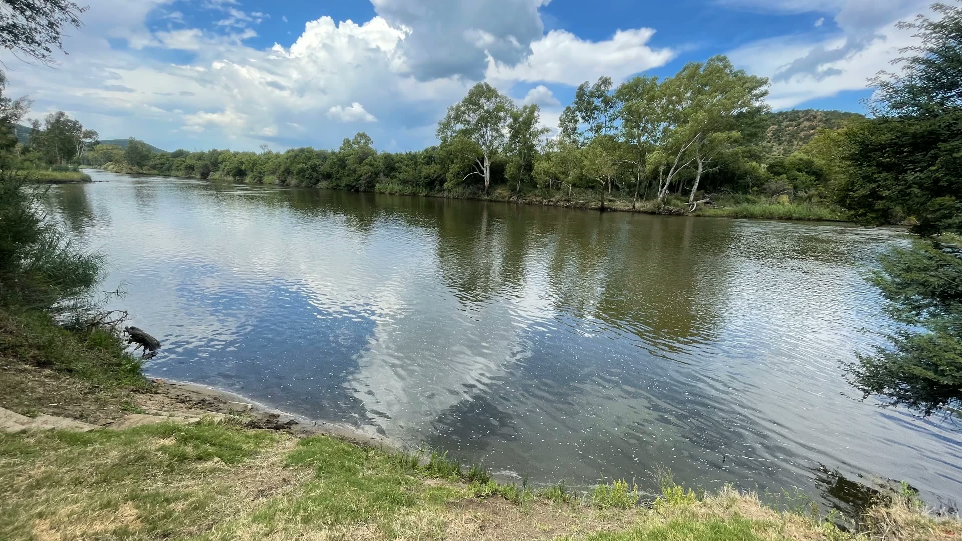 Calm stretch of the Vaal River with reflected clouds and bushveld banks